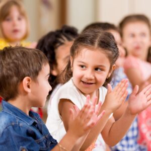 photo of young boy and girl clapping